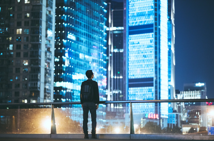 Young businessman looking at beautiful Shanghai night scene