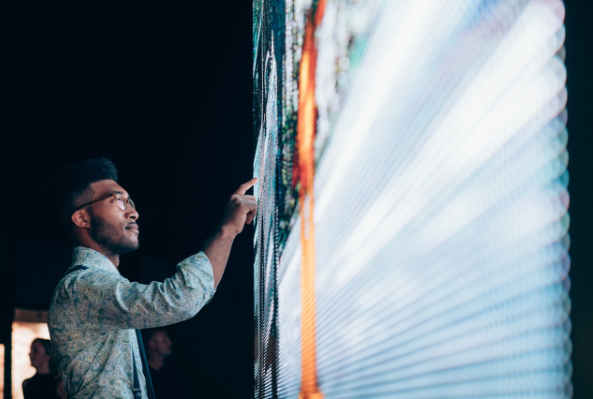 Businessman pointing at digital information board